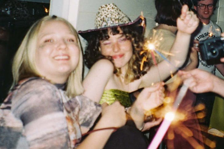 people at a party holding sparklers